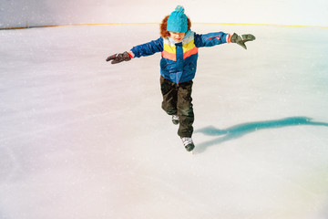 little boy skating on ice in winter nature © nadezhda1906