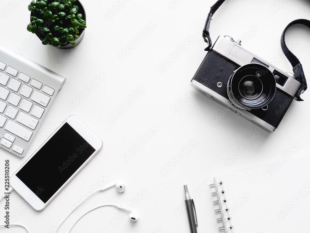 Poster top view of office desk workspace with notebook, smartphone and gadget on white background with copy