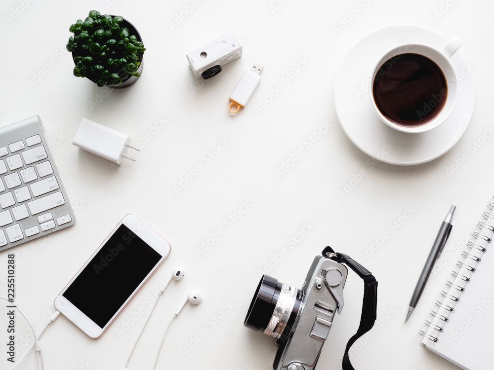 Poster top view of office desk workspace with notebook, smartphone and gadget on white background with copy