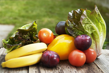 Fresh colorful vegetables ingredients fo vegan and healthy cooking or salad making on rustic background, top view, frame. Copy space.