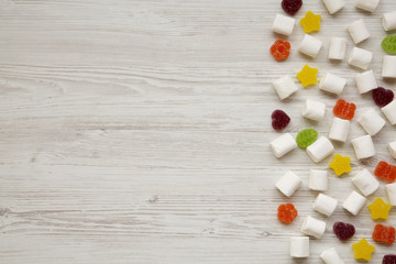 Candy on a white wooden surface, view from above. Flat lay, overhead. Copy space.