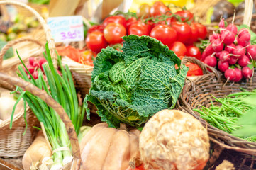 Savoy cabbage and other fresh vegetables for sale in a Parisian food market at the Marche rue d'Aligre