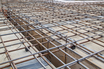 close up view of reinforcement of concrete with metal rods connected by wire. Preparation for...