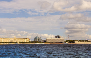 Obraz na płótnie Canvas Modern and ancient buildings stand side by side on the banks of the river in Saint-Petersburg.Russia.