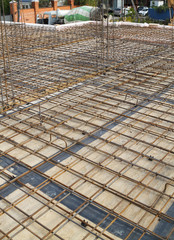 view of wooden formwork with metal holders, which will be filled with overlap between floors in country house under construction from foam block
