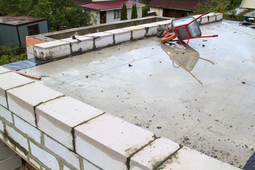 view of the hardened concrete slab base between floors. Construction of a country house made of foam blocks