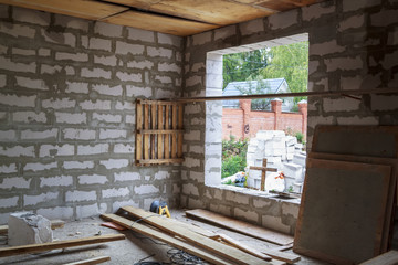 interior of a country house under construction. Site on which the walls are built of gas concrete blocks