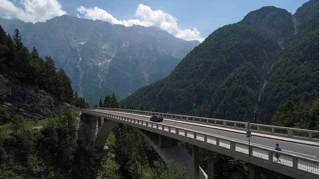 Aerial - Traffic on mountain viaduct in spring