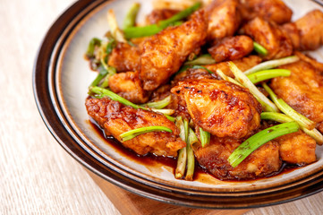 Delicious homemade stewed fish slices with scallion in wooden background, Taiwan delicacies, top view, copy space