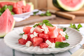 Plate with delicious watermelon salad on table, closeup