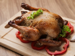 Roasted chicken on wooden board, food concept.