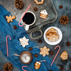 Christmas or New year food composition. Gingerbread, candy canes and coffee cup on dark table. Flat lay. Top view