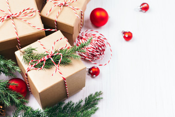 Christmas gift boxes collection with evergreen branches, candy cane Christmas rope and red Christmas balls. Angle view. Copy space.