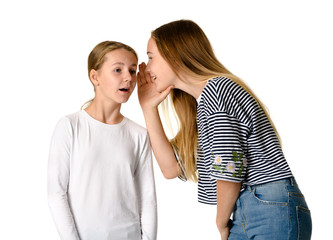 Young teen girls on white background whispering gossips