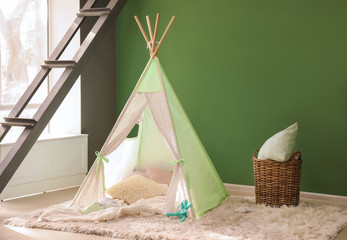 Cozy play tent for kids near color wall
