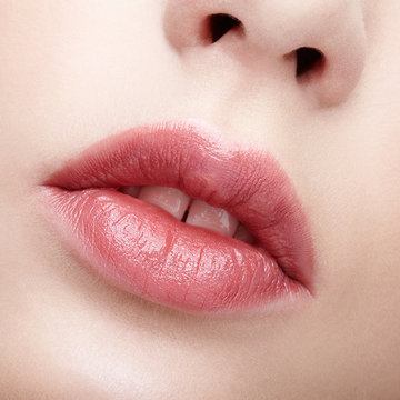 Closeup macro portrait of female part of face. Human woman lips with day beauty makeup. Girl with perfect lips shape