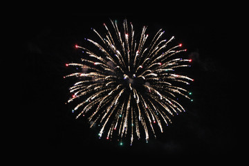 Fireworks. Firework. Fountain of bright yellow and multi-colored lights in the night sky during the holiday of New Year and Christmas