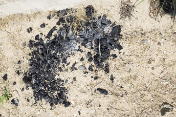 Charcoal spread on the beach