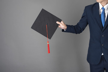 business man is holding graduation hat, business education concept