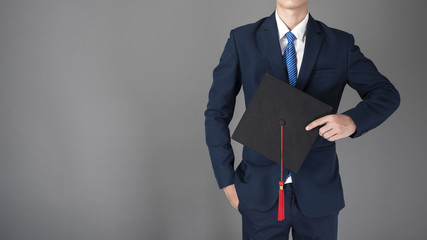 business man is holding graduation hat, business education concept