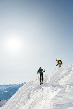 Male and female skiers skiing on a snowy mountain