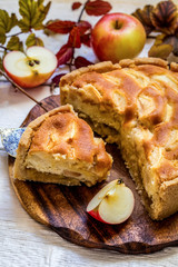 Apple pie on wooden chopping Board on white background