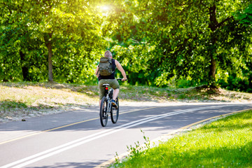 Naklejka premium Cyclist ride on the bike path in the city Park 