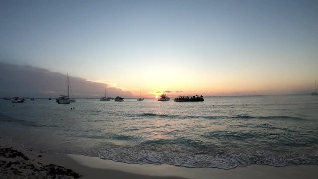 Beautiful sunset at the beach of Isla Mujeres at the Mexican Caribbean with boats