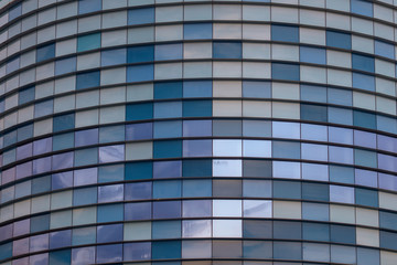 Glass building walls in the rays of sunset as background
