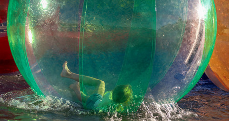 A child is playing in a large bowl on the water