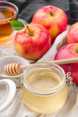 Jewish holiday Rosh Hashanah background with honey and apples on wooden table.