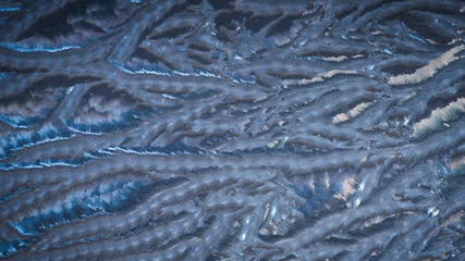 Blue frozen glass - natural winter background.