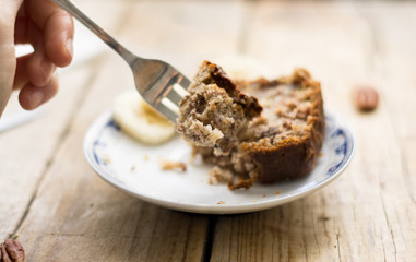 Eating homemade banana breadth a silver fork