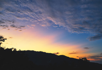 Spectacular sunset over mountains and trees on a tropical island