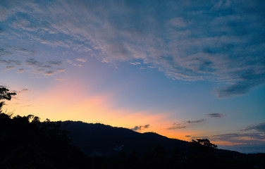 Spectacular sunset over mountains and trees on a tropical island