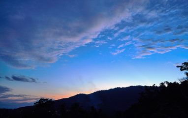 Spectacular sunset over mountains and trees on a tropical island
