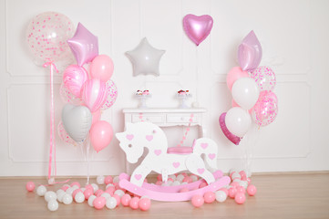 Decorations for children birthday. Decorations for holiday party. A lot of balloons pink and white colors. 