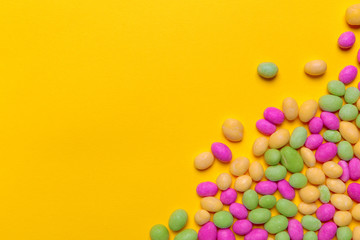 colored candies on yellow background