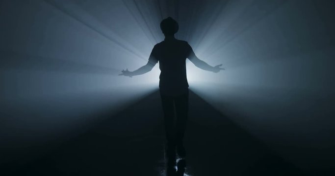 Pop singer is dancing in silhouette