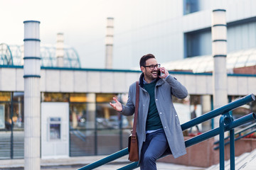 Successful modern businessman talking on the phone