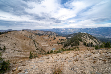 Beautiful view from the summit of mountains in the Bridger Teton National Forest near Jackson Wyoming, featuring a small alpine lake. Autumn season