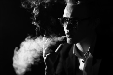 portrait of a man with glasses smoking a cigar