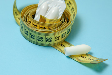 Suppository for anal or vaginal use and yellow measuring tape. Candles for the treatment of...