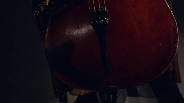 The cellist performs on stage.