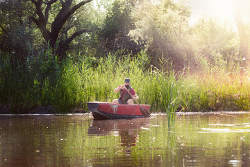 fisherman rowing in a wooden boat