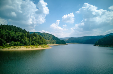 reservoir with clouds and forest