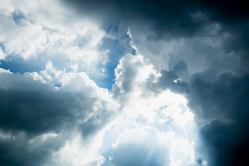Sun behide clouds and blue sky, silhouette