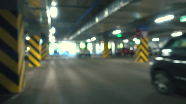 Big parking area, car leaves parking lot.