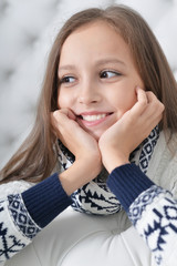 Portrait of cute girl posing on sofa