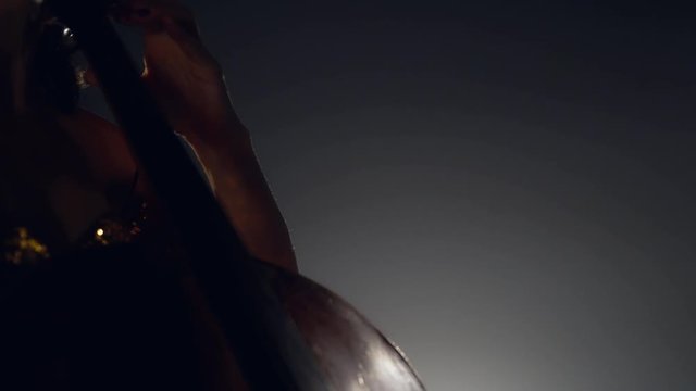 The cellist performs on stage.